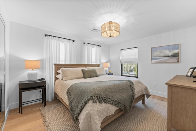 65 Sky Dr, Windham, ME 04062 - bedroom featuring visible vents, light wood-style flooring, baseboards, and an inviting chandelier