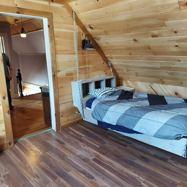 bedroom featuring wood finished floors, lofted ceiling, wood walls, and wooden ceiling