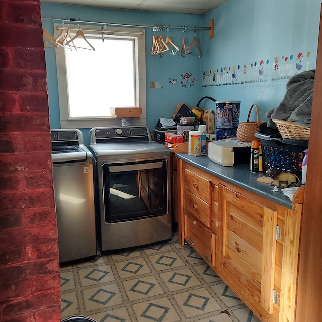 laundry area featuring laundry area, light floors, and washing machine and clothes dryer