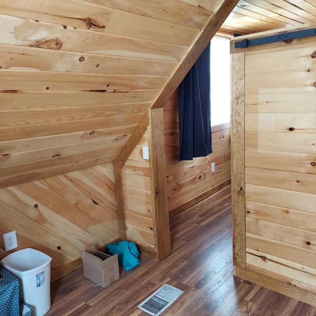 additional living space featuring wooden ceiling, wood finished floors, visible vents, and wood walls