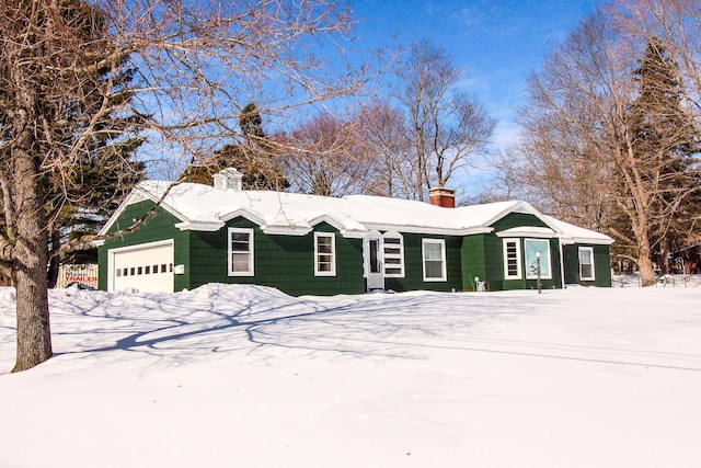 view of front of home with a garage and a chimney