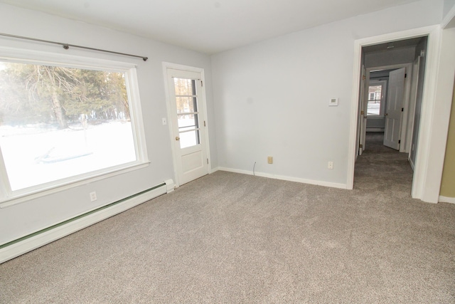 carpeted spare room featuring baseboards and baseboard heating