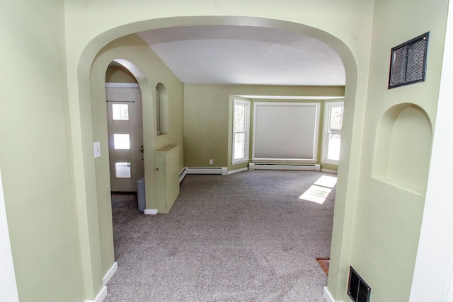 carpeted foyer entrance featuring a baseboard radiator, visible vents, baseboard heating, and baseboards