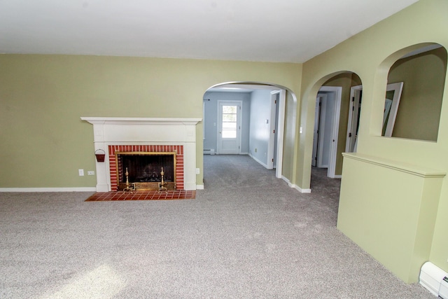 unfurnished living room featuring carpet floors, a brick fireplace, and baseboard heating