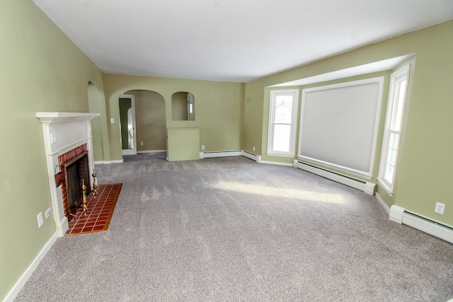 unfurnished living room featuring baseboards, a baseboard radiator, carpet flooring, and a brick fireplace