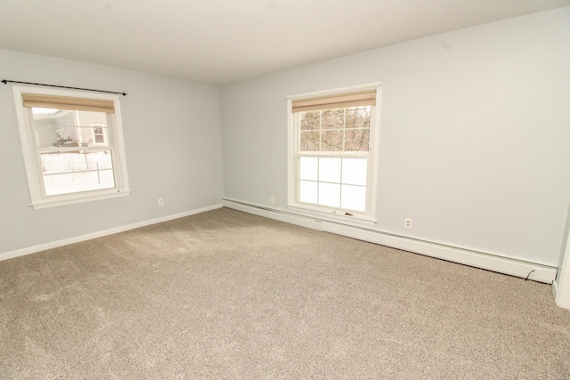 carpeted spare room featuring a baseboard radiator and baseboards