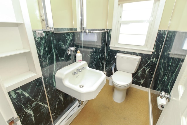 bathroom with wainscoting, a sink, and toilet