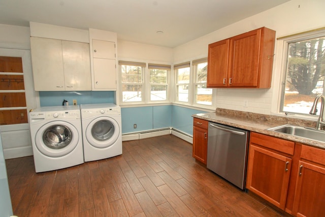 washroom featuring washing machine and dryer, dark wood-style flooring, a sink, and baseboard heating