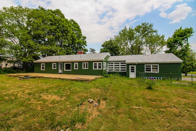 269 Main St, Orono, ME 04473 - rear view of house featuring a chimney, a deck, and a lawn