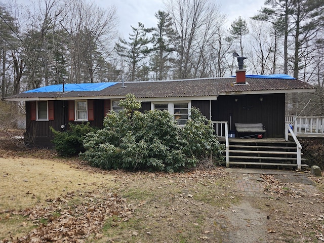 view of front of house featuring board and batten siding and a wooden deck