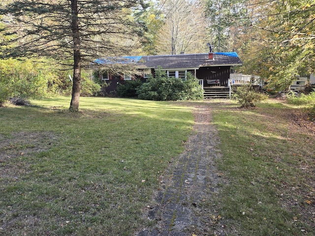 view of front of house featuring a deck and a front yard