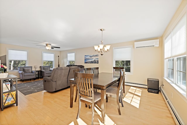 dining space with a baseboard heating unit, light wood-style flooring, and a wall mounted AC