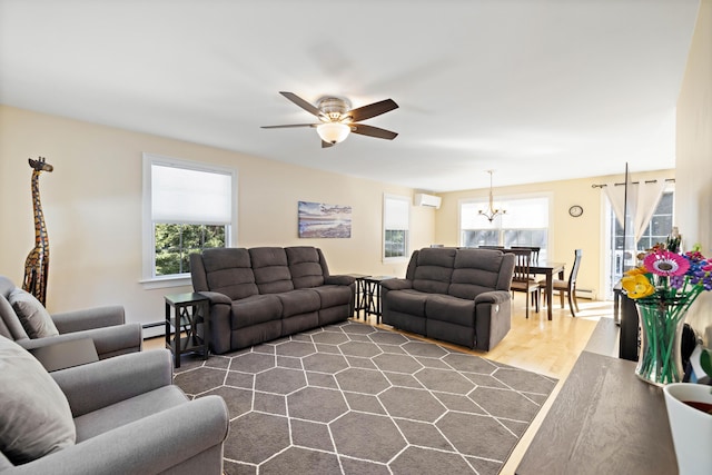 living area with baseboard heating, ceiling fan with notable chandelier, a wall mounted AC, and dark wood-type flooring