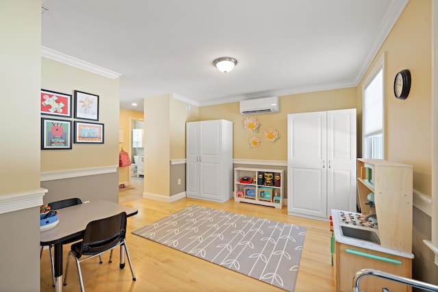 office with baseboards, light wood-style floors, crown molding, and a wall mounted AC