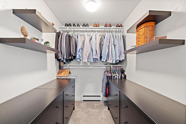 spacious closet featuring light carpet and baseboard heating