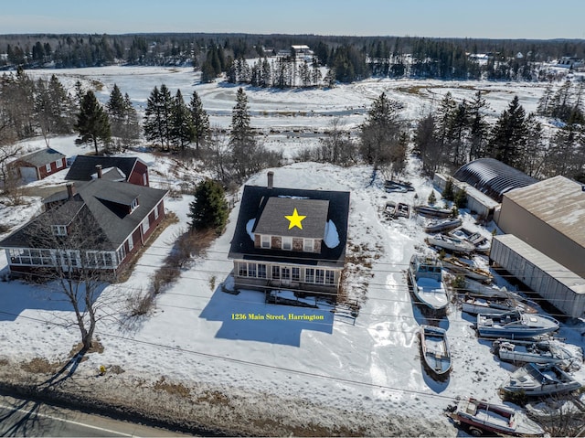 snowy aerial view featuring a view of trees