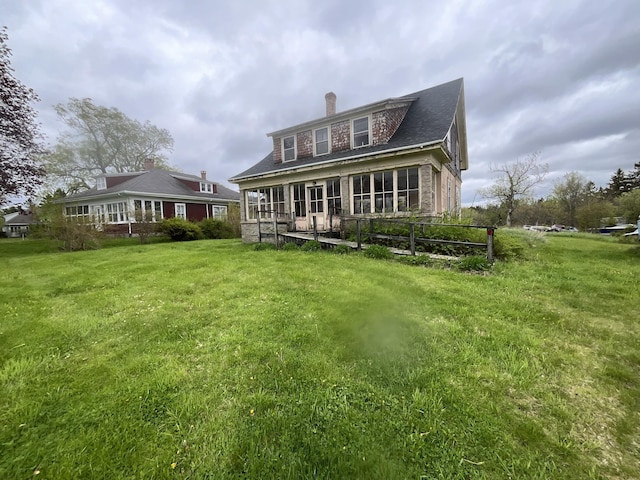 1236 Main St, Harrington, ME 04643 - rear view of property featuring a chimney and a yard