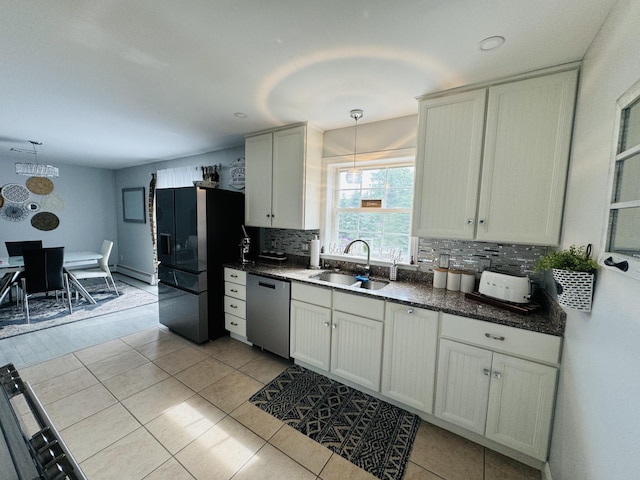 kitchen featuring a sink, black fridge with ice dispenser, dishwasher, tasteful backsplash, and decorative light fixtures