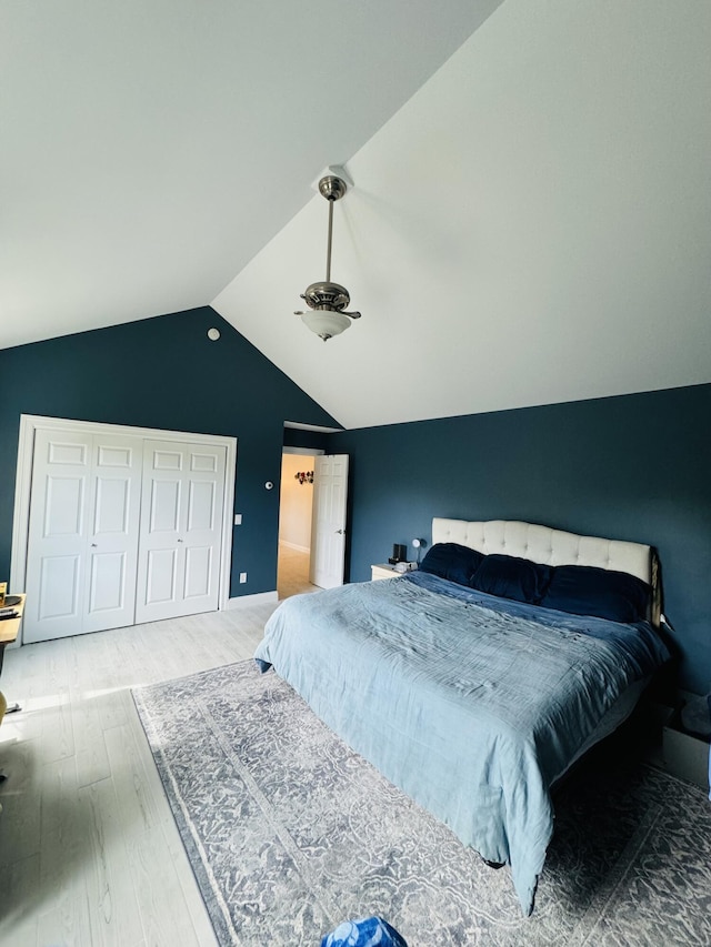 bedroom with vaulted ceiling and wood finished floors