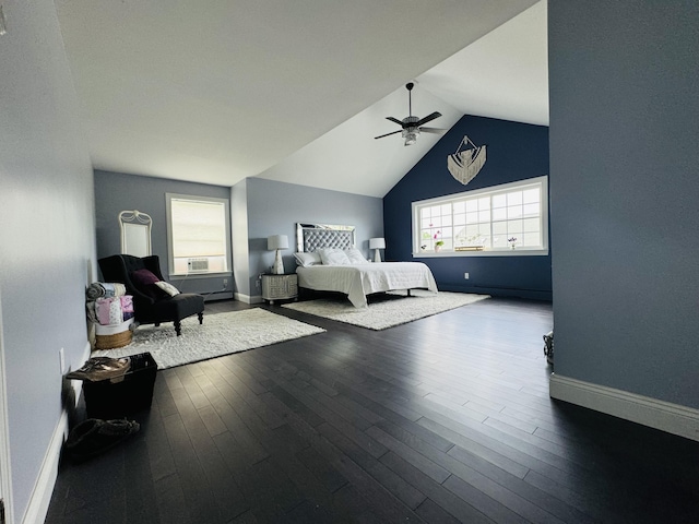 bedroom with a ceiling fan, vaulted ceiling, baseboards, and wood finished floors