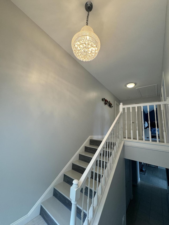 stairs with attic access and baseboards