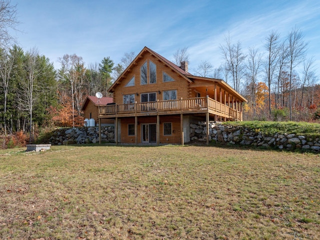 back of house featuring a deck, log exterior, and a lawn