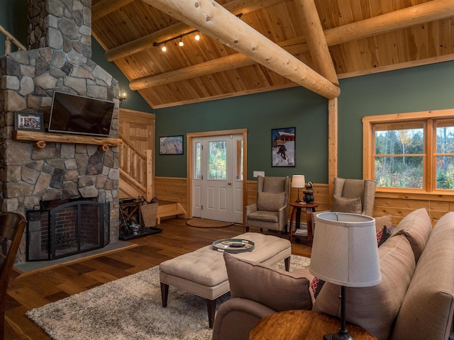 living room with a wainscoted wall, wood ceiling, a wealth of natural light, and wood finished floors