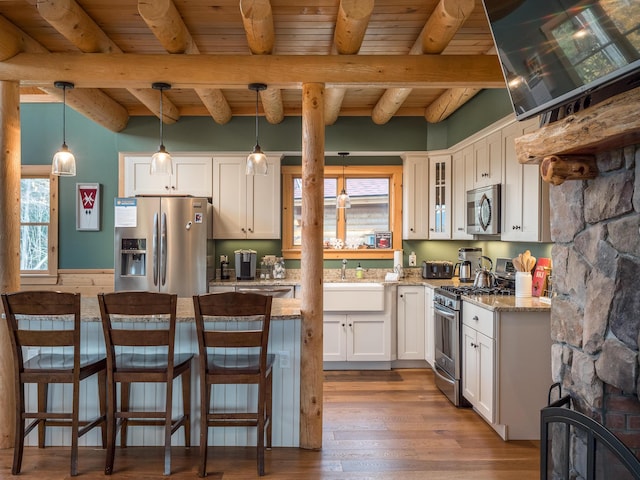 kitchen with white cabinets, wood ceiling, dark wood-type flooring, beamed ceiling, and stainless steel appliances