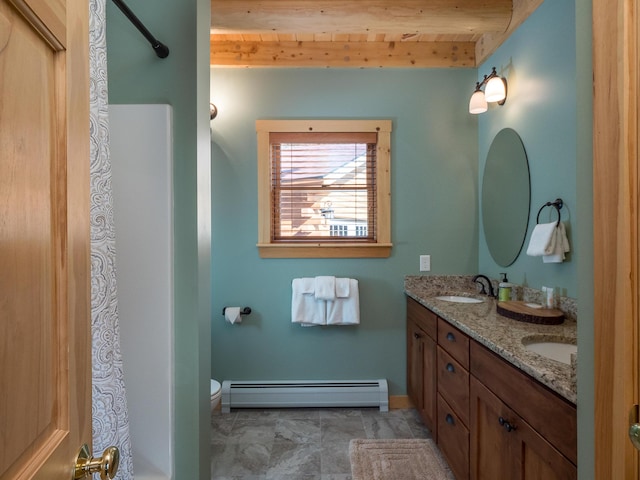 bathroom with beam ceiling, a sink, baseboard heating, and double vanity