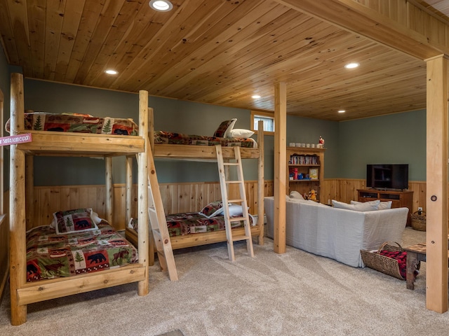 carpeted bedroom with a wainscoted wall, wood ceiling, and recessed lighting