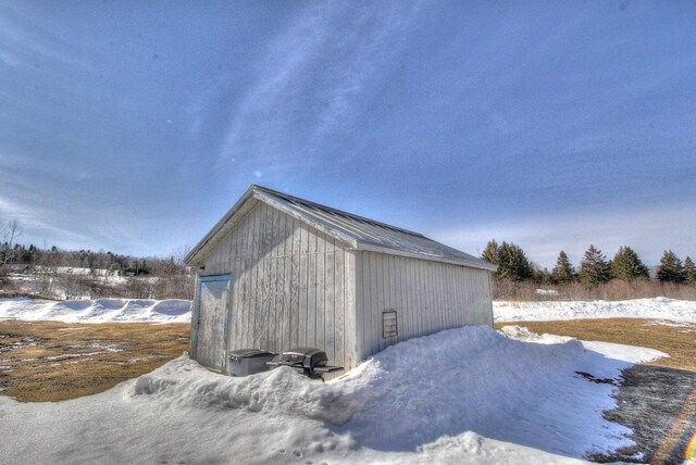 snow covered structure with an outdoor structure