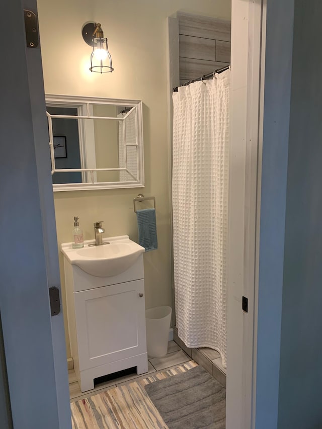 full bath with wood finished floors, vanity, and a shower with curtain