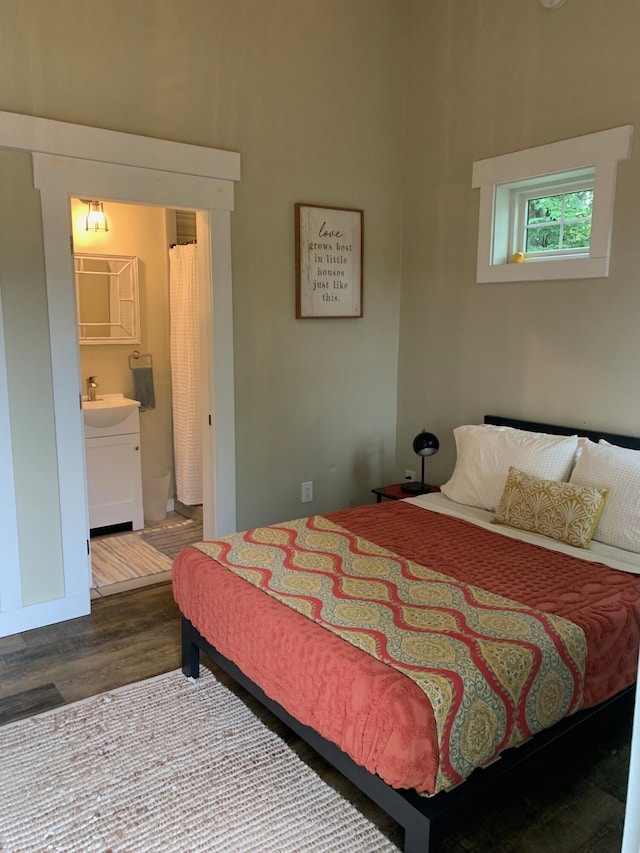 bedroom featuring dark wood-style floors and a sink