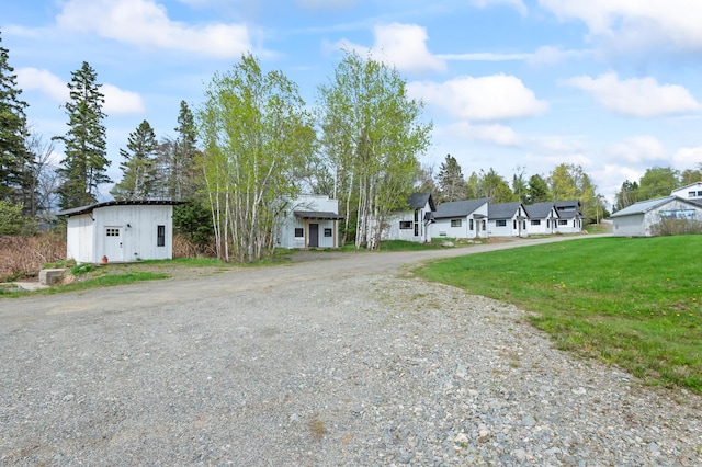 2342 Main St, Rangeley, ME 04970 - view of front of home with dirt driveway, a front lawn, and a residential view