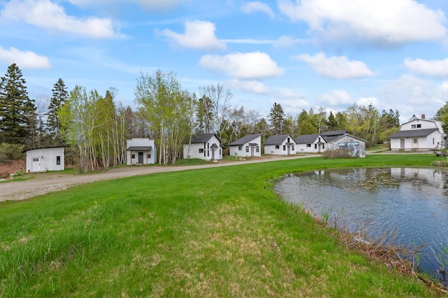 2342 Main St, Rangeley, ME 04970 - view of green lawn featuring curved driveway, a residential view, and a water view