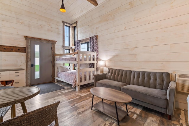 2342 Main St, Rangeley, ME 04970 - bedroom with wood walls, wood-type flooring, and a wall mounted air conditioner