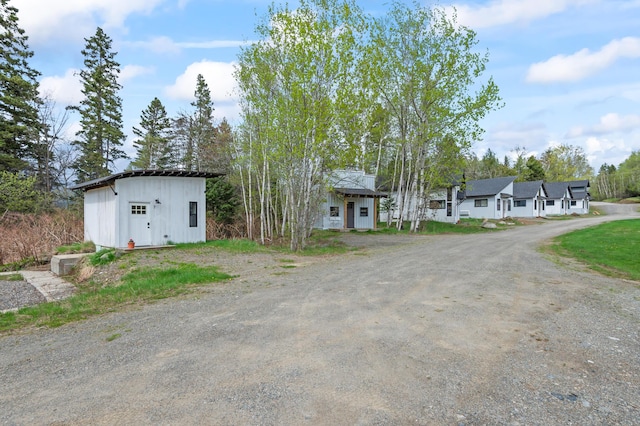 2342 Main St, Rangeley, ME 04970 - view of front of home with an outdoor structure and board and batten siding