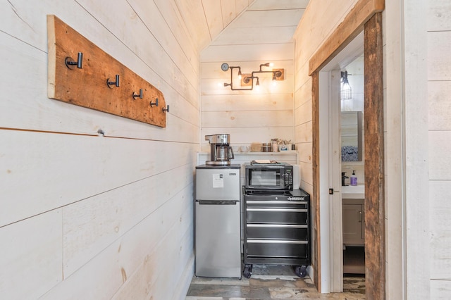2342 Main St, Rangeley, ME 04970 - kitchen featuring freestanding refrigerator, wood walls, and wood ceiling