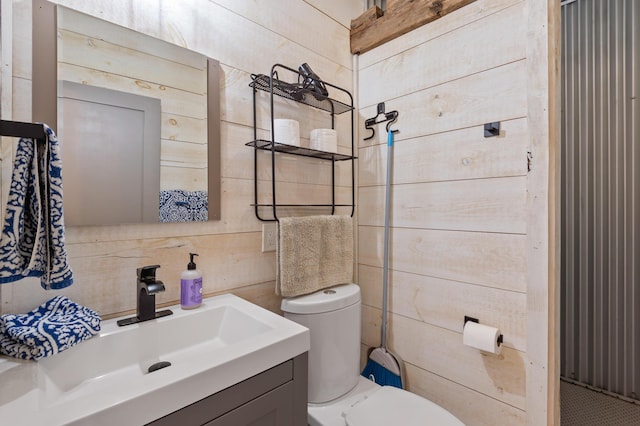 2342 Main St, Rangeley, ME 04970 - bathroom with toilet, backsplash, vanity, and wood walls