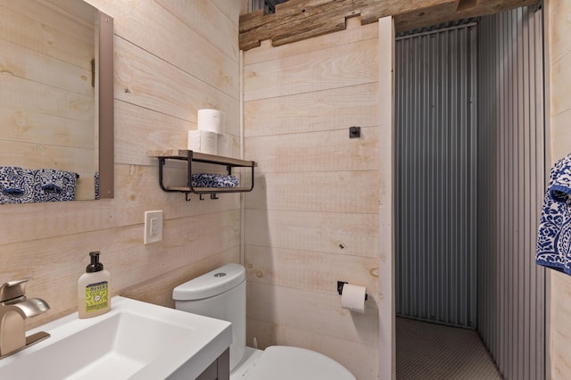 2342 Main St, Rangeley, ME 04970 - bathroom featuring toilet, wooden walls, and vanity