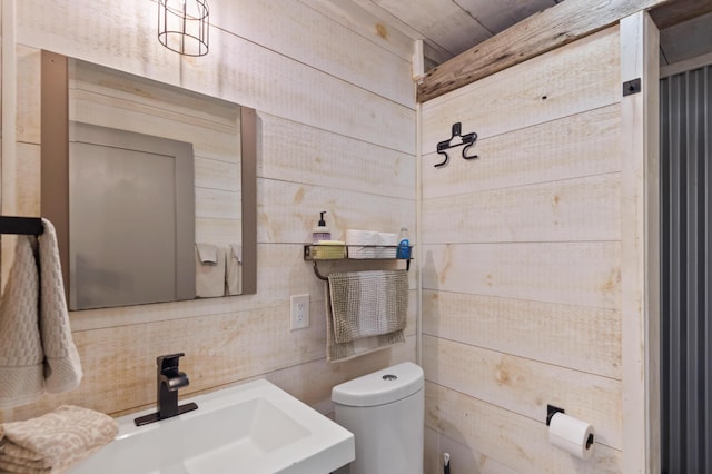 2342 Main St, Rangeley, ME 04970 - half bath with toilet, a sink, and wood walls