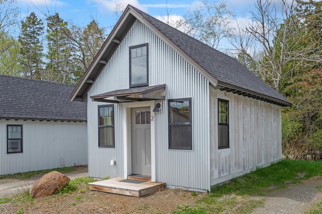 2342 Main St, Rangeley, ME 04970 - view of front of property with a shingled roof and an outdoor structure