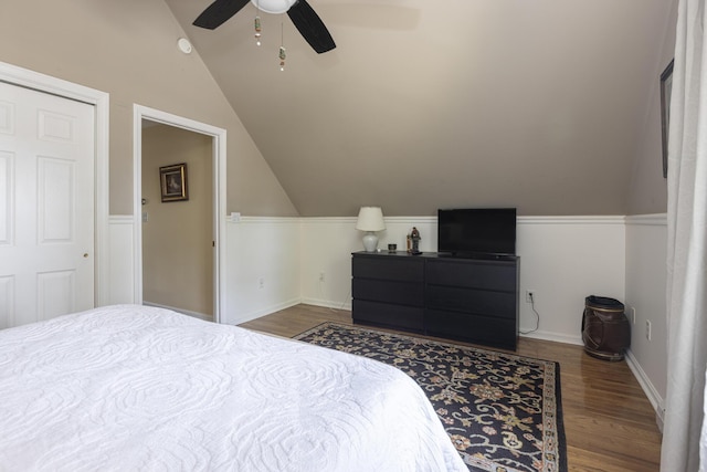 bedroom featuring baseboards, wood finished floors, a ceiling fan, and vaulted ceiling