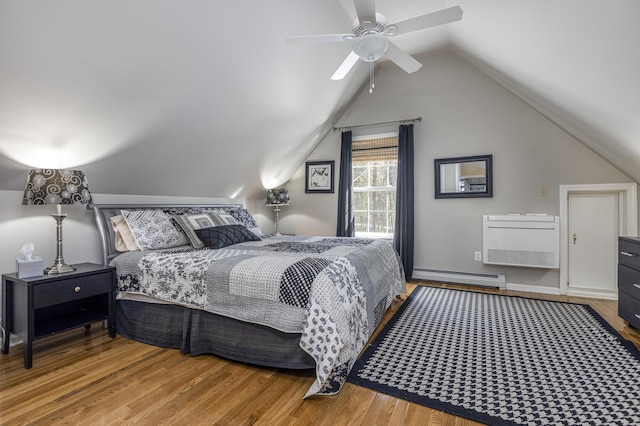 bedroom featuring ceiling fan, baseboard heating, wood finished floors, and vaulted ceiling