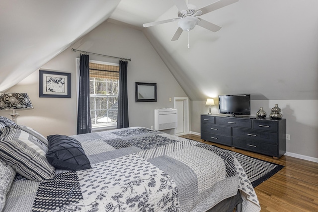 bedroom featuring baseboards, wood finished floors, a ceiling fan, and vaulted ceiling