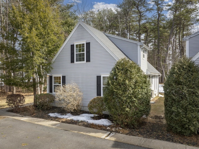 view of property exterior featuring a shingled roof