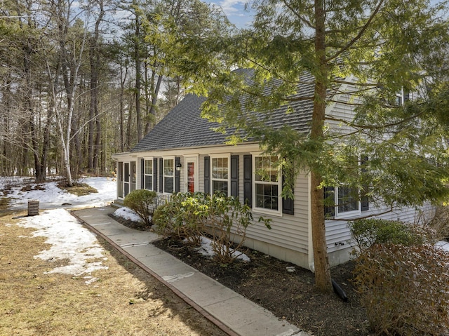 view of side of home featuring a shingled roof