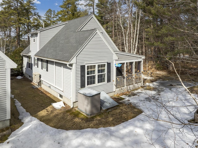 back of property with roof with shingles