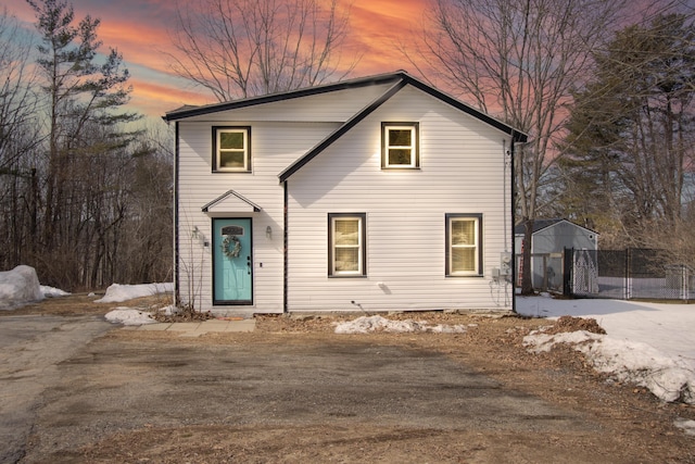 traditional home featuring fence