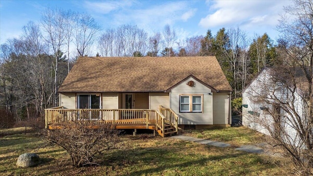 view of front of property with roof with shingles and a deck